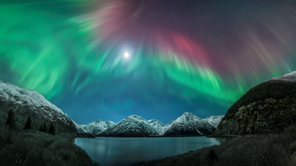 Aurora and a full moon above Portage Lake and Kenai Mountains