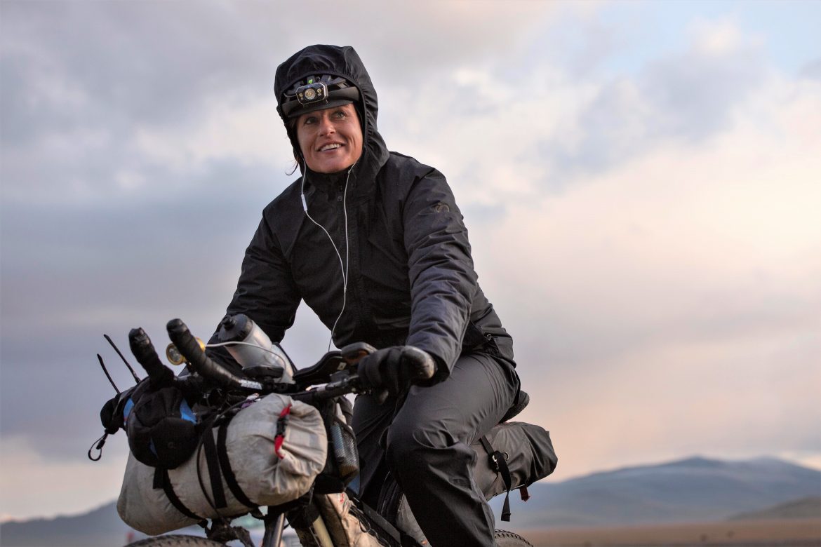 Lael Wilcox Biked Every Alaska Road Lael Wilcox dressed in black riding her bike during the Silk Mountain Road Race