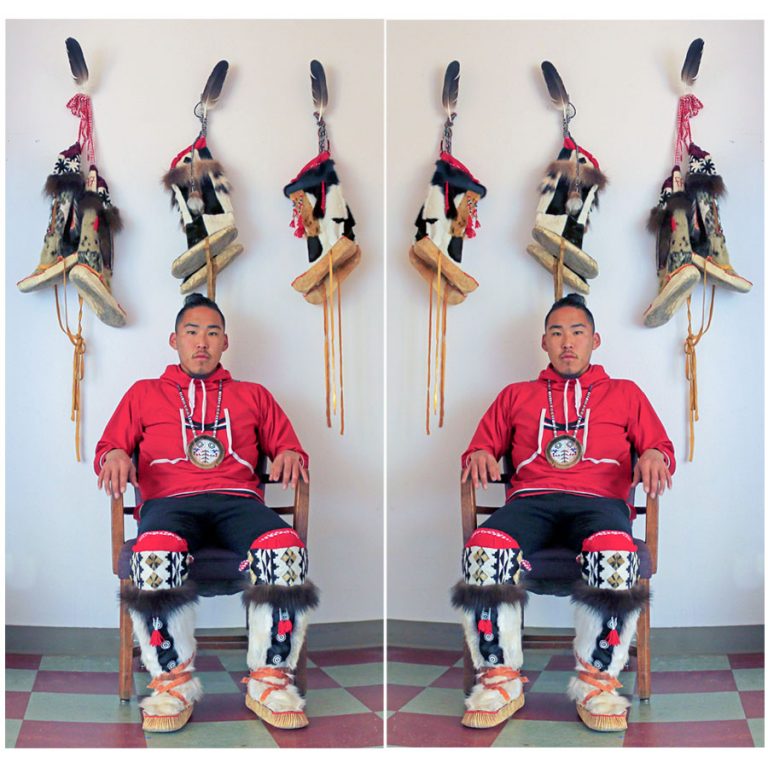 Yupik artist Golga Oscar sitting in traditional dress