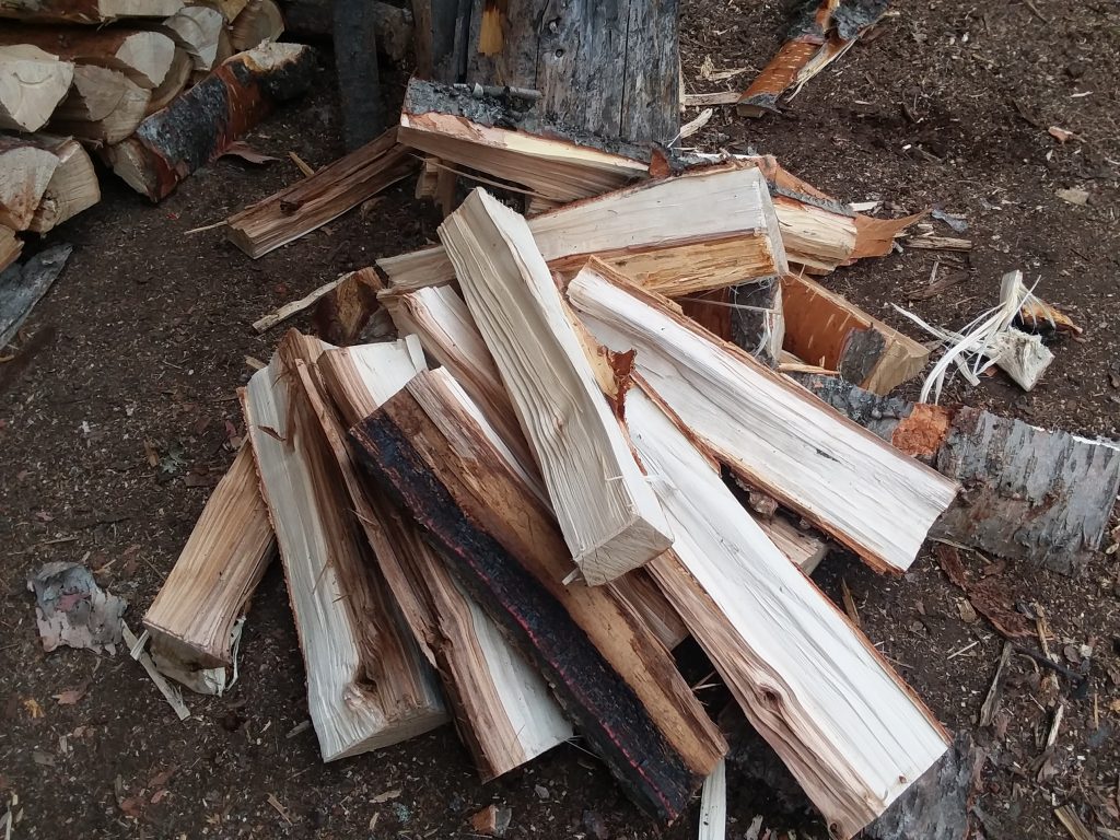 messy stack of split birch firewood