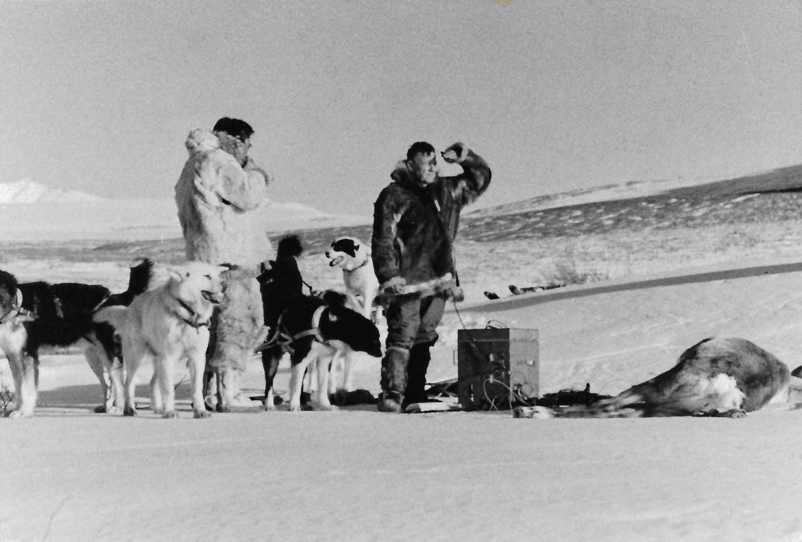 Two men and dogs on snow. Laurence Irving and Simon Paneak