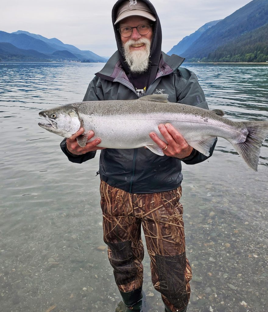Vic Walker holds up a silver salmon