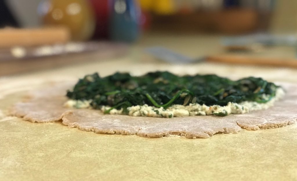 Galette crust with spinach and ricotta spread in middle