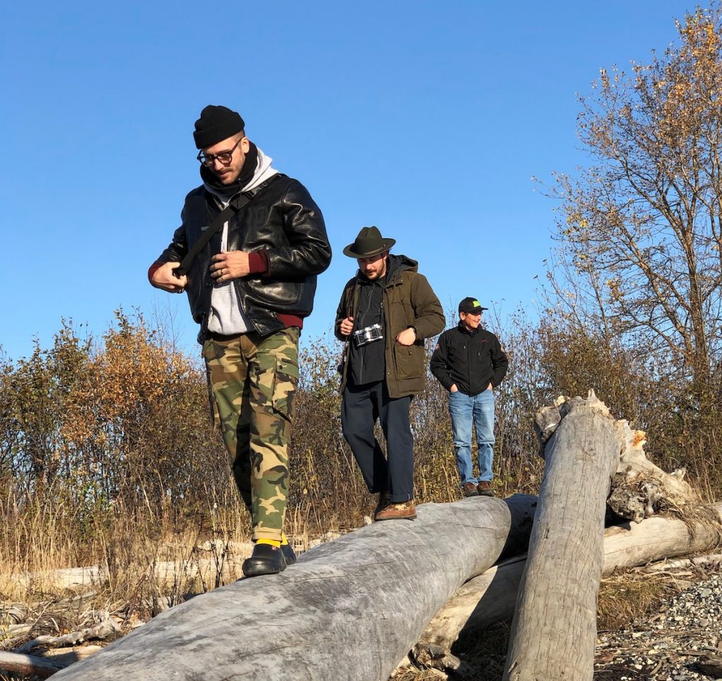 Portugal. The man band members walk on driftwood