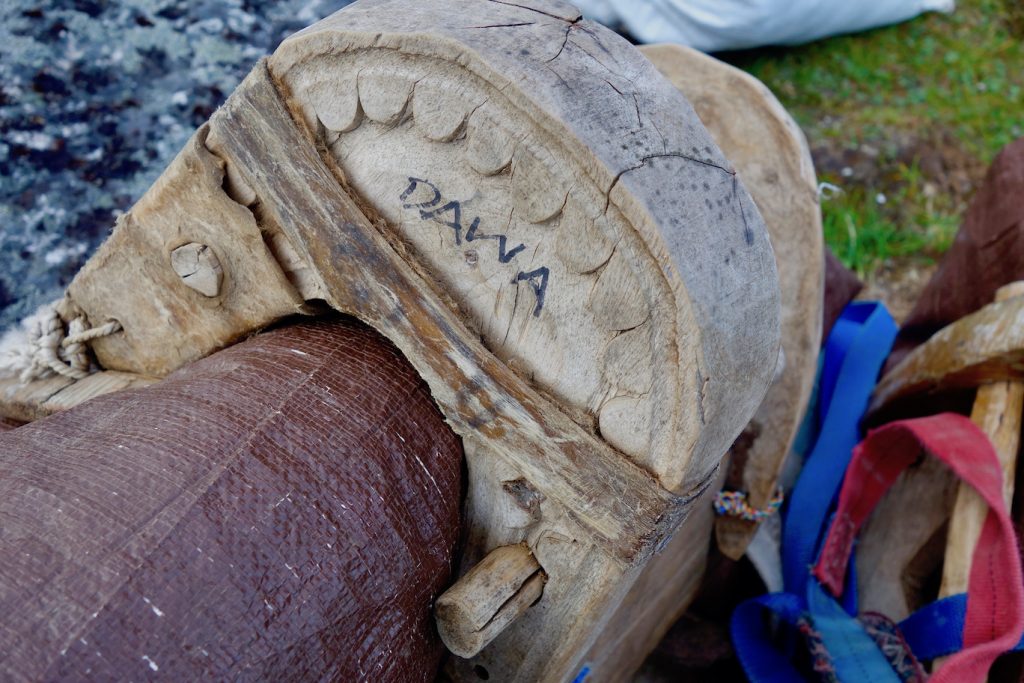 Close on a wooden packsaddle with Dawa written in sharpie