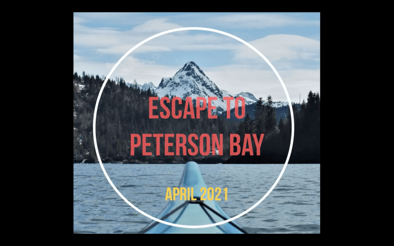Kayak and water in still image from video with title, Escape to Peterson Bay