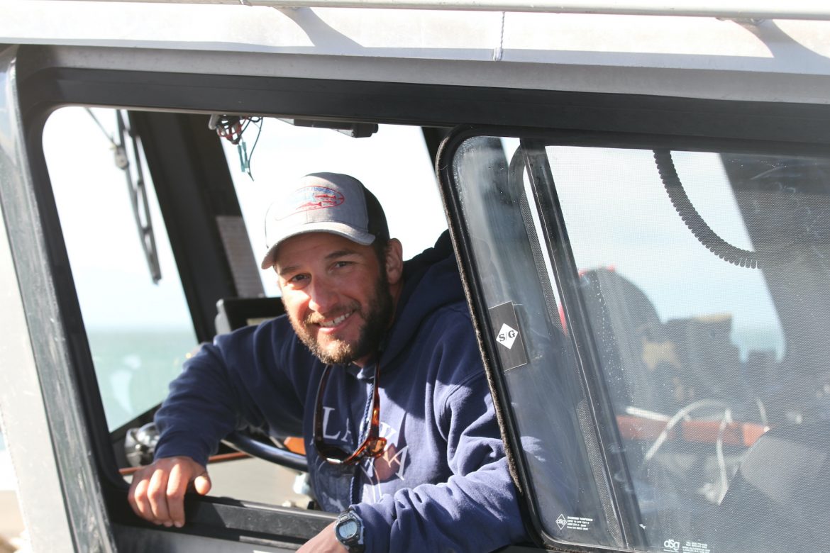 Steve Kurian posing in the window of a boat