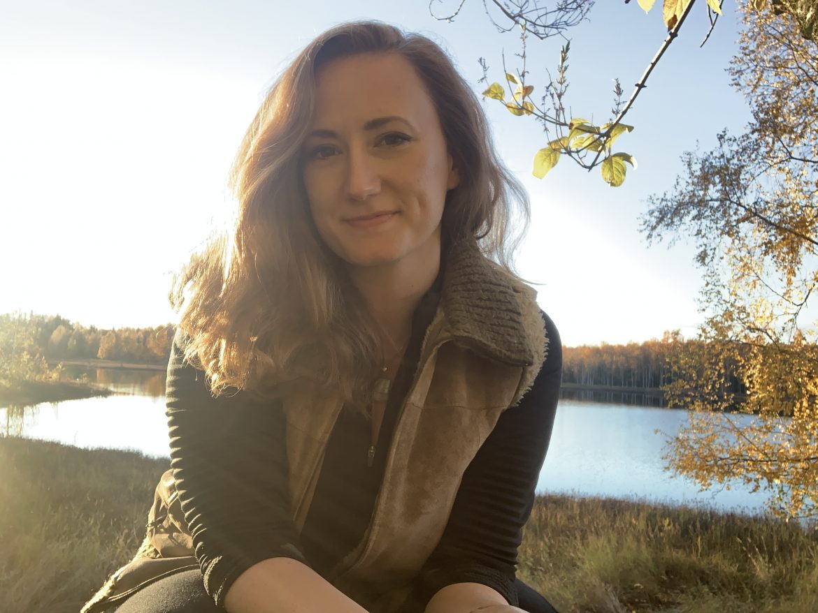Kate Bass on a sunny fall day in front of a lake