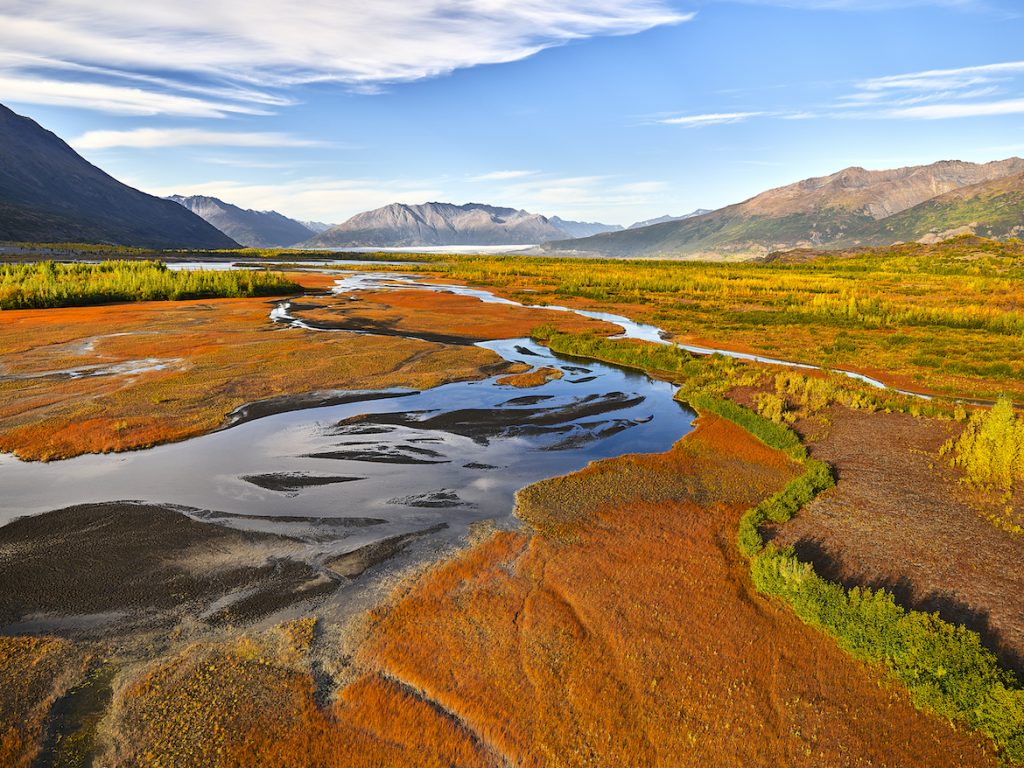 Aerial photograph. River wends through landscape of fall colors