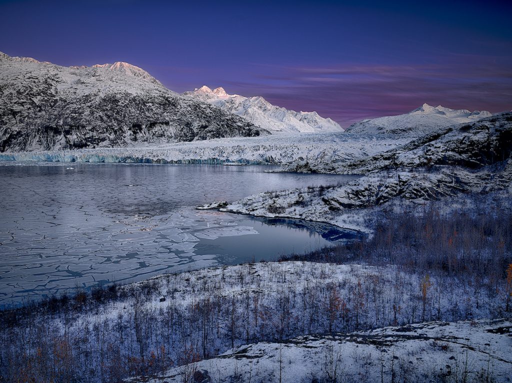 Winter landscape, partially frozen lake, glacier.
