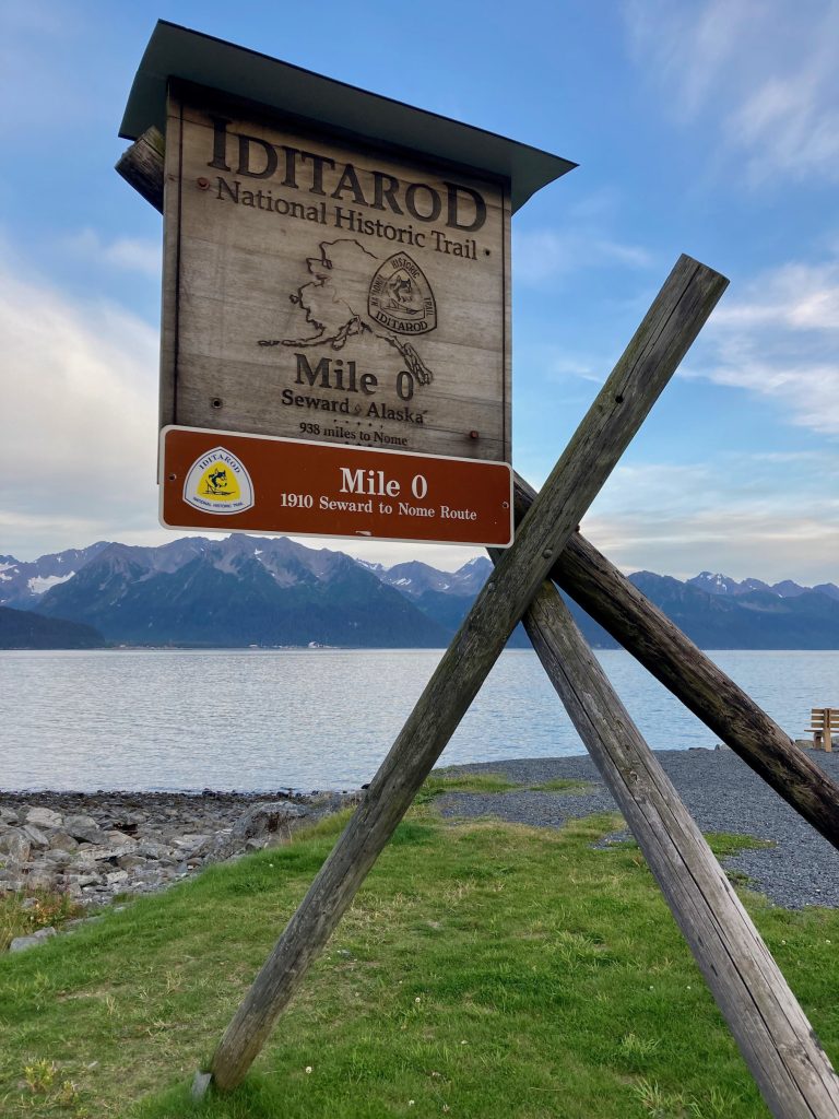 Wooden sign near the coast marks the spot of mile zero of the historic Iditarod trail