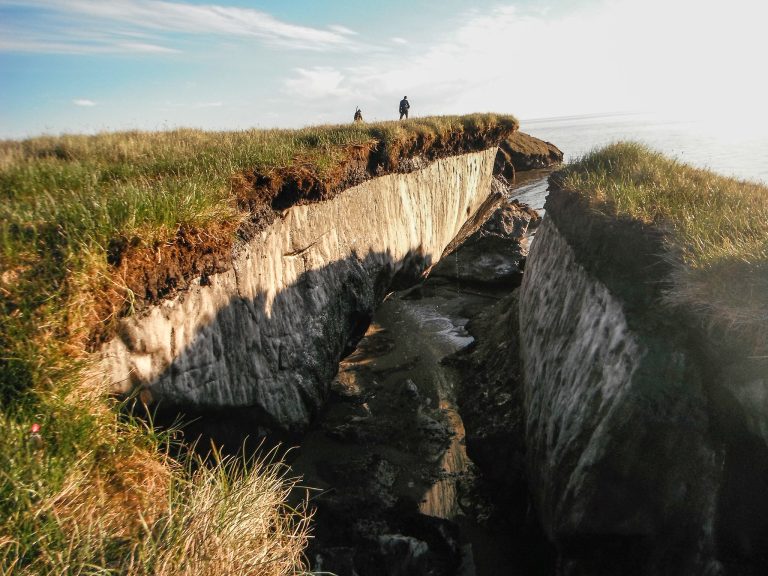 Mapping for the Future a big chunk of land has broken off from the coast and sits on the edge of the ocean. Chunk is from a bluff about 30-feet high