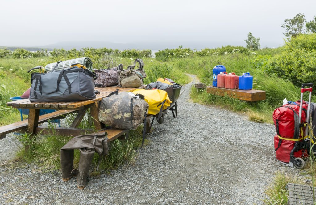 Bags sit on a table at a camping site at McNeil River