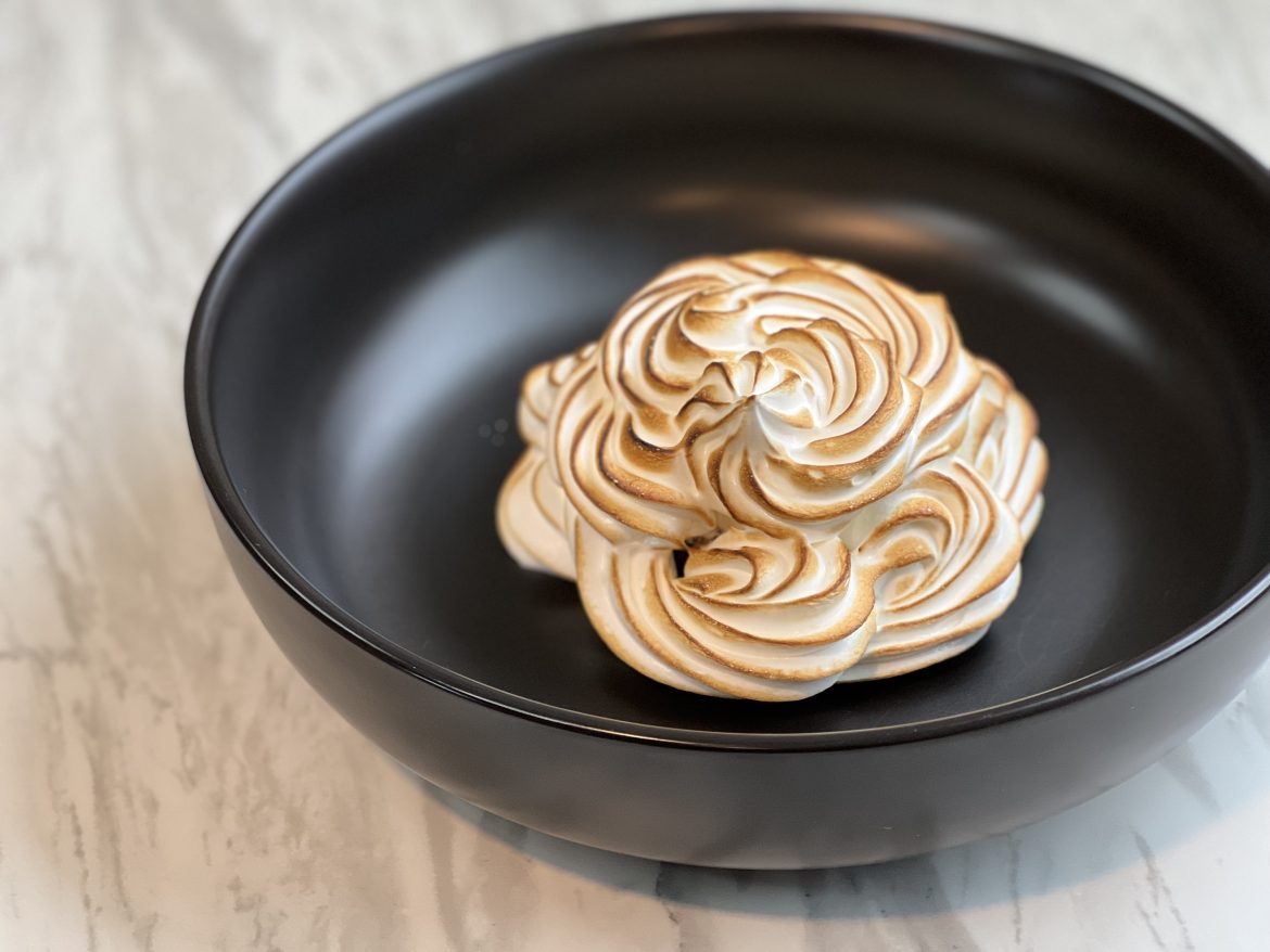 Swirls of meringue colored with a torch in a black dish